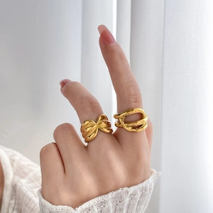 Minimalist 18K gold plated hollow twist and abstract line rings on a model's hand