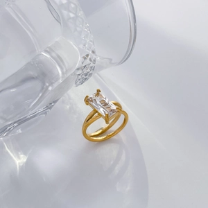 Macro view of 18K gold plated steel ring featuring a large rectangular green zircon stone