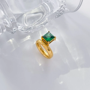 Detailed side view of 18K gold plated ring featuring a square green zircon in claw setting
