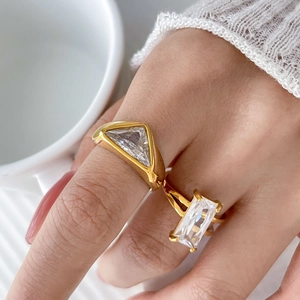 Macro shot of 18K gold plated rings with large triangular and rectangular zircon stones