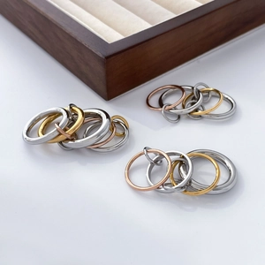 Macro shot of interlocking 18K gold-plated titanium steel rings in tricolor finish