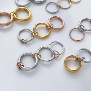 Macro shot of 18K gold plated multi-colored interlocking rings in gold, silver, and rose gold