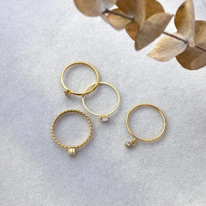 Four-piece gold titanium steel ring set with zircon charms and twisted band texture