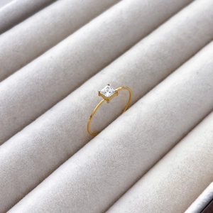 Macro shot of 18K gold ring featuring a square-cut zircon in a classic four-prong setting