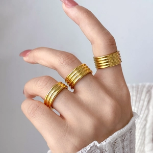Three-piece stackable 18K gold-plated titanium rings featuring textured wavy rib designs