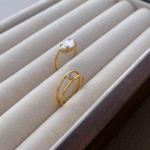 Close-up of 18K gold plated titanium ring with marquise-cut and small round zirconias