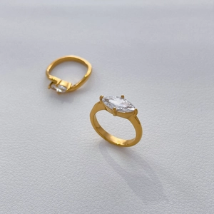 Detailed view of two marquise-cut zircon rings in 18K gold-plated stainless steel