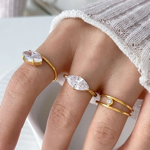 Detail of 18K gold plated rings featuring marquise and round cubic zirconia stones