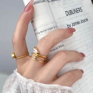 Double layer 18K gold plated steel ring with teardrop zircon worn on model hand