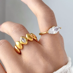 Macro view of 18K gold plated ring with marquise cut zircon and double layer round stones