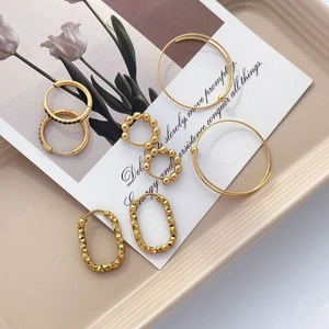 Golden titanium steel beaded hoop earrings set with textured U-shape and black stones