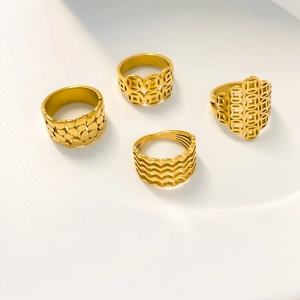 Detailed close-up of four gold hollowed-out coin and wave textured titanium steel rings
