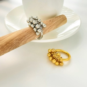 Detail of 18K gold and silver titanium steel rings with clustered metal bead waves