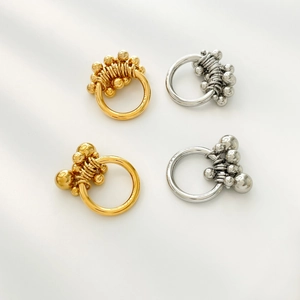 Detail view of gold and silver wave bead rings with minimalist metallic wire accents