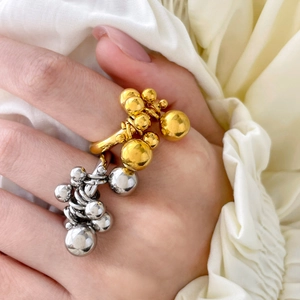Close-up of double-layer titanium steel rings with gold and silver bead clusters