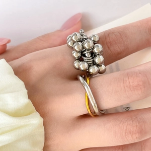 Dual-tone 18K gold plated wavy stainless steel ring with polished bead cluster