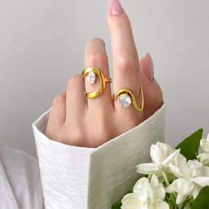 Détail de bagues empilables plaquées or 18 carats avec de gros zircons ronds et gouttes