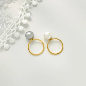 Detail of titanium steel open rings featuring natural white and grey-purple pearls
