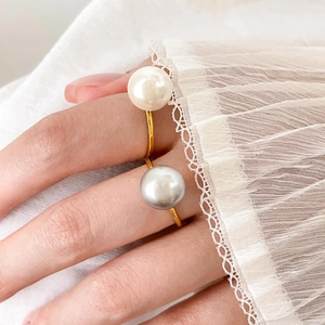 Detail of elegant open ring featuring natural freshwater pearls on a slim gold band