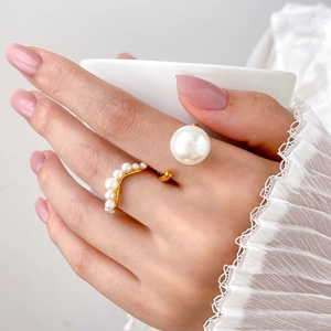 Detail view of adjustable titanium steel ring with fresh water pearls on a hand