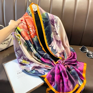 Luxurious satin silk shawl with vibrant peony floral print and orange border detail