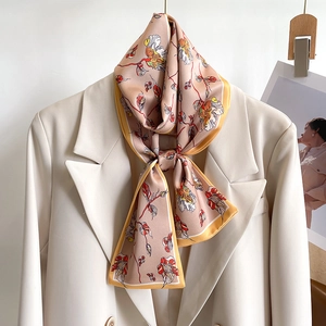 Elegant floral silk-feel long neck scarf in dusty pink on white blazer lapel