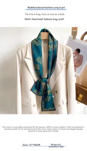 Detail of 12x148cm dark green silk scarf with golden ginkgo leaves on a white suit