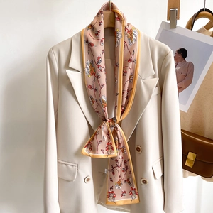Elegant floral silk scarf on a beige suit with a vintage pattern and yellow border