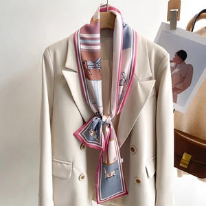 Elegant long skinny silk scarf with horse print on beige blazer for a retro French look