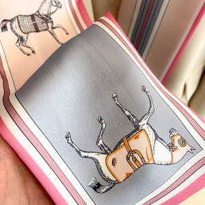 Detailed close-up of equestrian print silk scarf showing twill texture and soft horse pattern