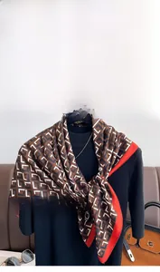 Detailed view of luxury geometric monogram pattern on silky twill square scarf