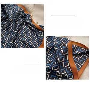 Macro detail of high-quality hand-rolled edges on a silk scarf with geometric patterns