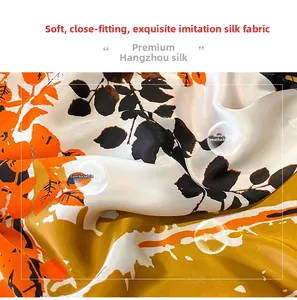 Macro detail of breathable silk-like scarf with orange and black floral patterns