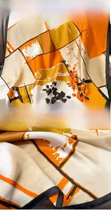 Detail of silk-feel scarf showing vibrant floral patterns and premium hemmed edges