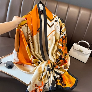 Artistic orange and black silk-feel shawl scarf with leaf prints for women