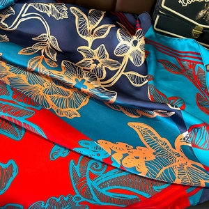 Elegant oversized floral silk-like scarf with deep blue and gold botanical patterns