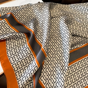 Silk-like shawl in vibrant orange and grey with geometric monogram print for women