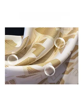 Close-up of twill silk scarf showing breathable texture and gold geometric pattern