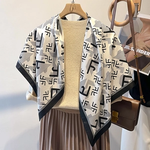 Detail of elegant letter print silk scarf with geometric twill patterns for women