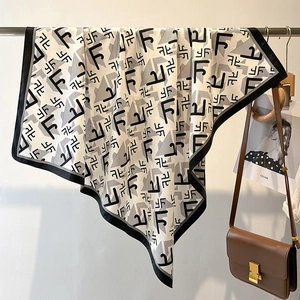 Detail of elegant black and white letter print silk scarf with luxury vintage pattern
