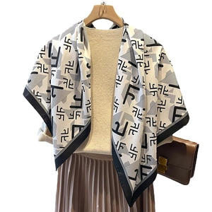 Elegant black and white geometric letter print silk scarf with wide black border detail