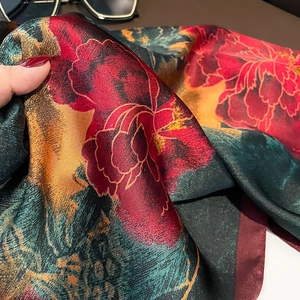 Detailed view of satin square scarf featuring vibrant peony floral prints and smooth texture