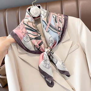 Silky square scarf with vintage carriage print styled on a cream blazer lapel