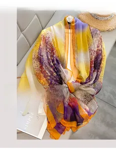 Close-up of vibrant tie-dye oversized beach shawl with orange finished edges