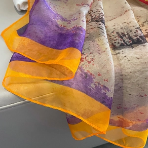 Oversized silk scarf with purple and orange abstract ink print and fine orange stitched edges