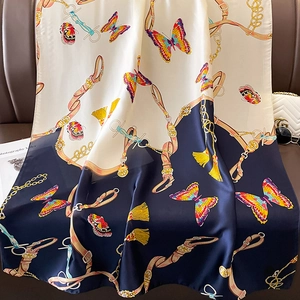 Navy blue and beige faux silk scarf featuring butterfly and metal chain prints