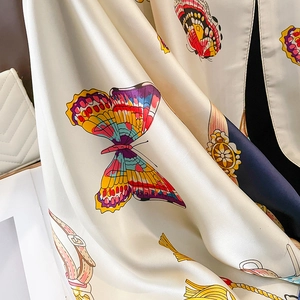 Detail of silk scarf showing vintage equestrian patterns and realistic butterfly prints