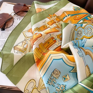 Close-up of luxury green silk scarf with classical prints and elegant belt patterns