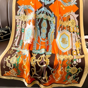 Detailed view of luxury silk scarf with equestrian horse bit and chain print patterns