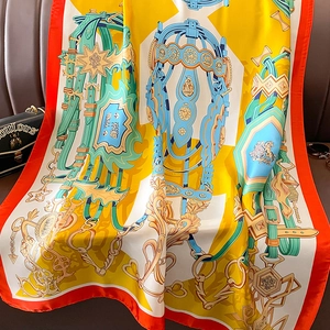 Close-up of silk scarf with vintage equestrian harness patterns and smooth texture